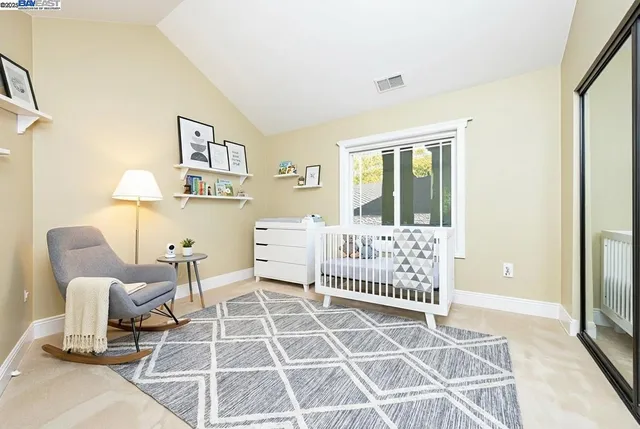 a spacious bedroom with a large bed and a fireplace