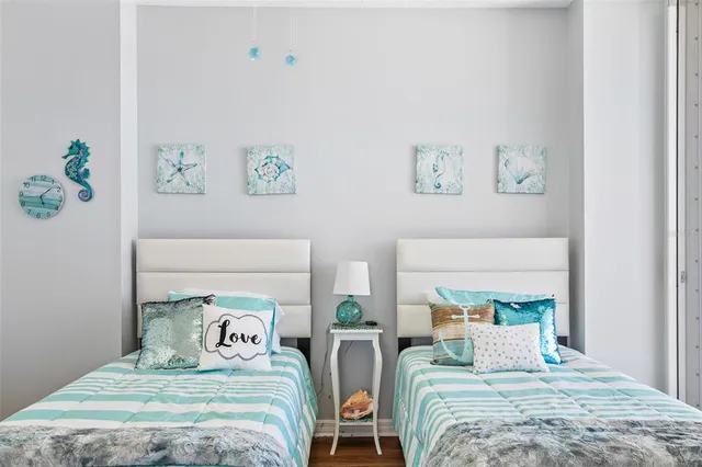 a bedroom with a bed and a painting on the wall