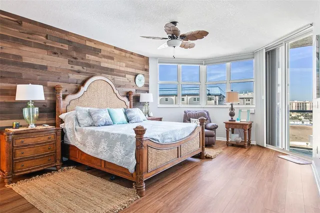 a bedroom with a bed wooden floor and window