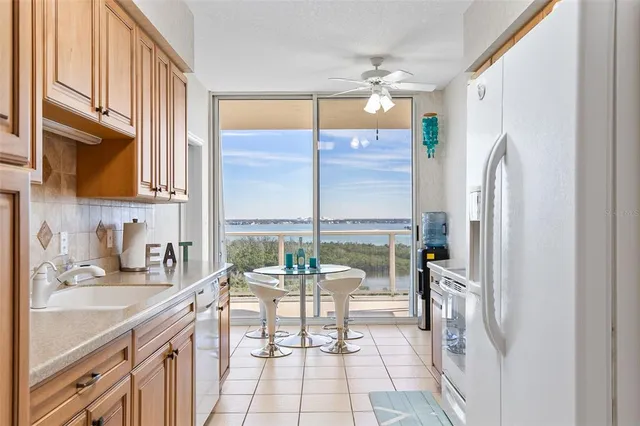 a kitchen with a sink refrigerator and cabinets