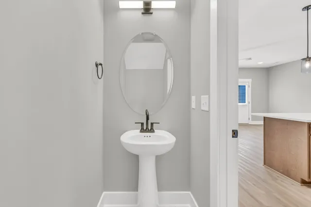 a bathroom with a sink a mirror and shower