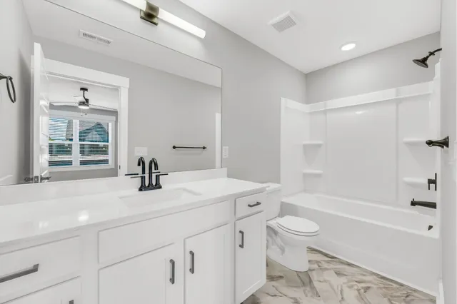 a bathroom with a sink a toilet and a bathtub