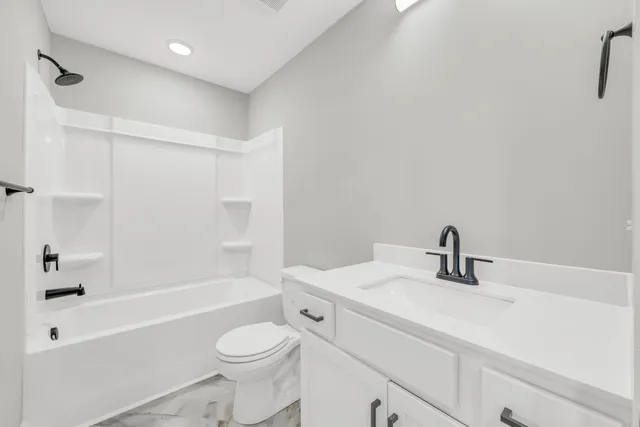 a bathroom with a sink a toilet and a bathtub