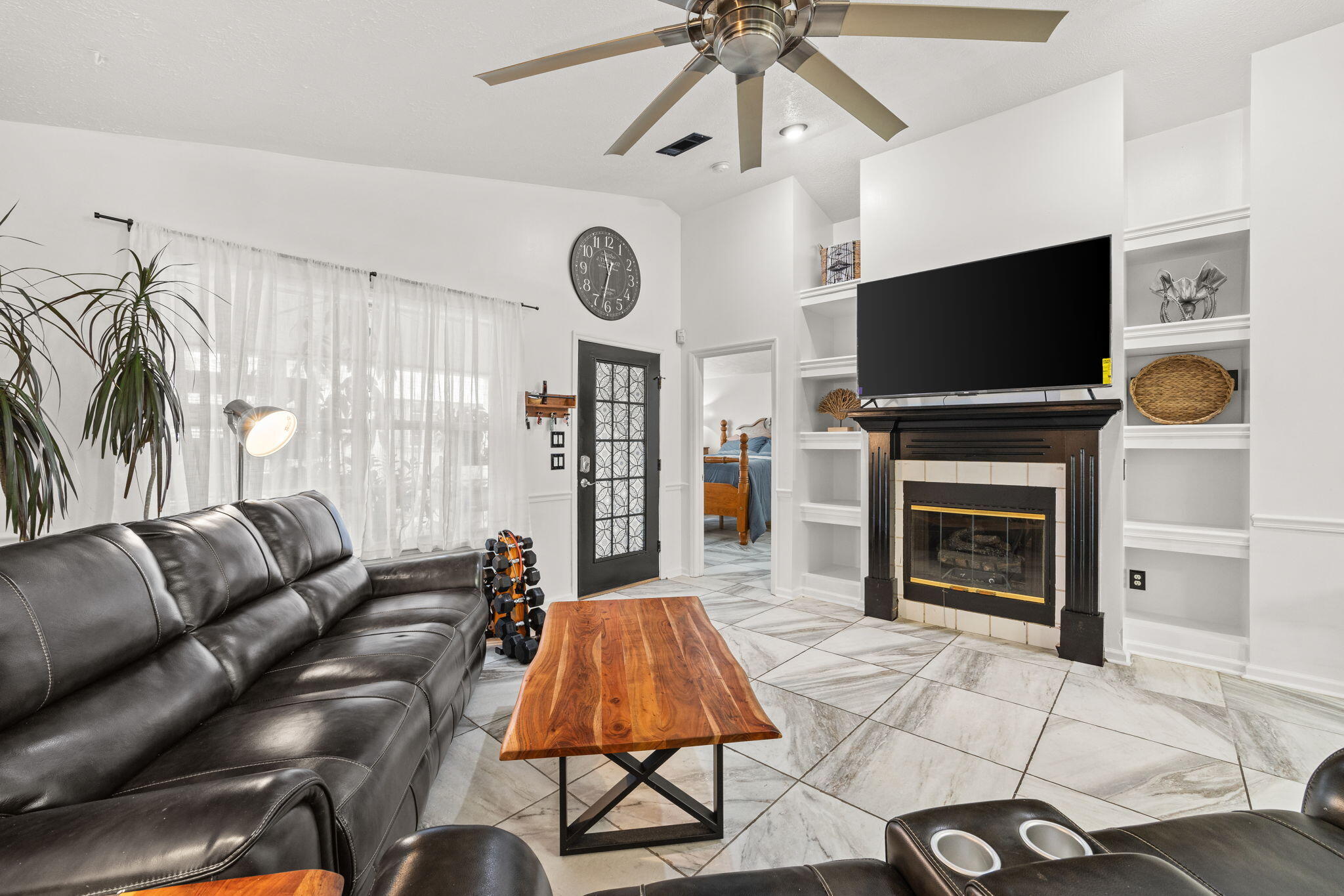 17826 Front Beach Road Panama City Beach, FL 32413 - Photo 12 of 34 a living room with furniture a flat screen tv and a fireplace