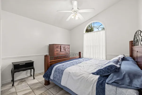 a bedroom with a bed and a chandelier