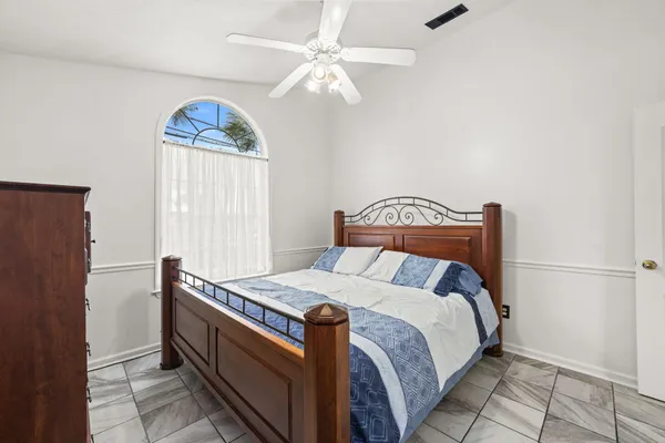 a bedroom with bed and a window