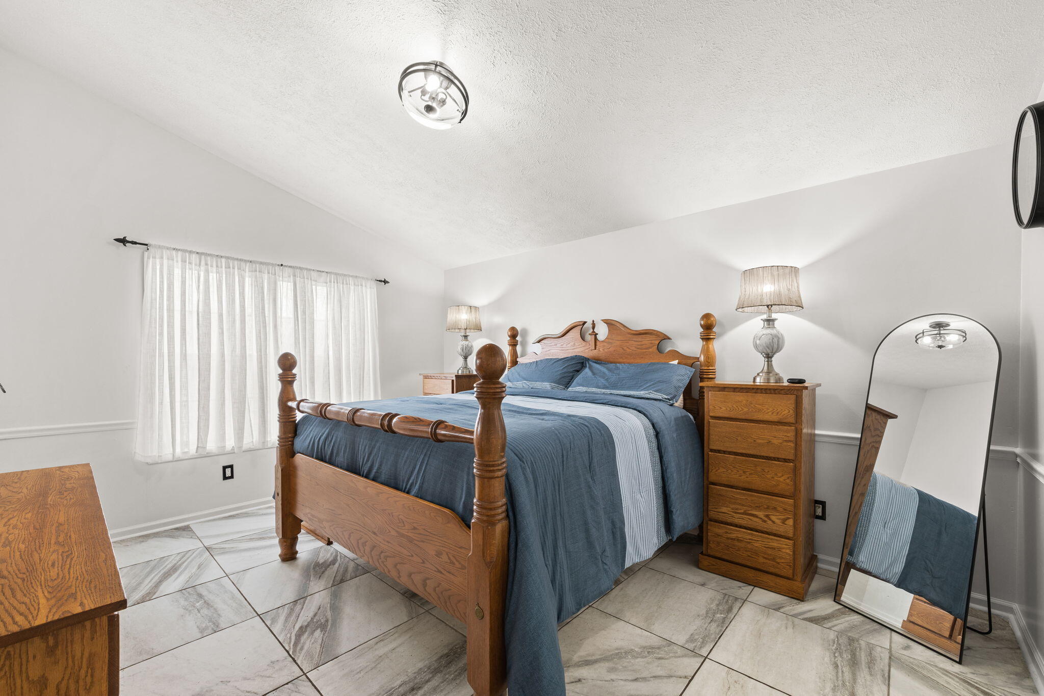 17826 Front Beach Road Panama City Beach, FL 32413 - Photo 17 of 34 a bedroom with a bed and a mirror on dresser