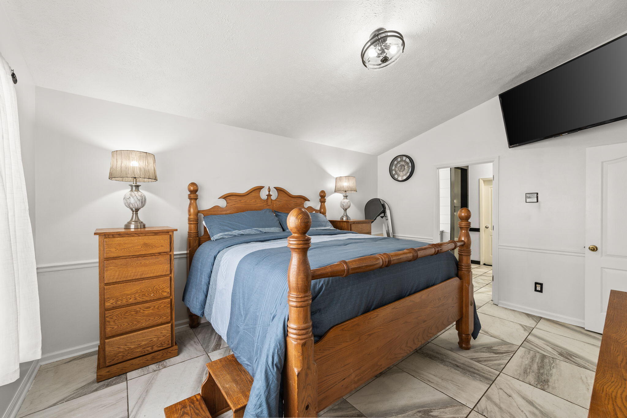 17826 Front Beach Road Panama City Beach, FL 32413 - Photo 18 of 34 a bedroom with a bed and a flat tv screen on wall