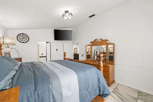 a bed room with a bed and a television
