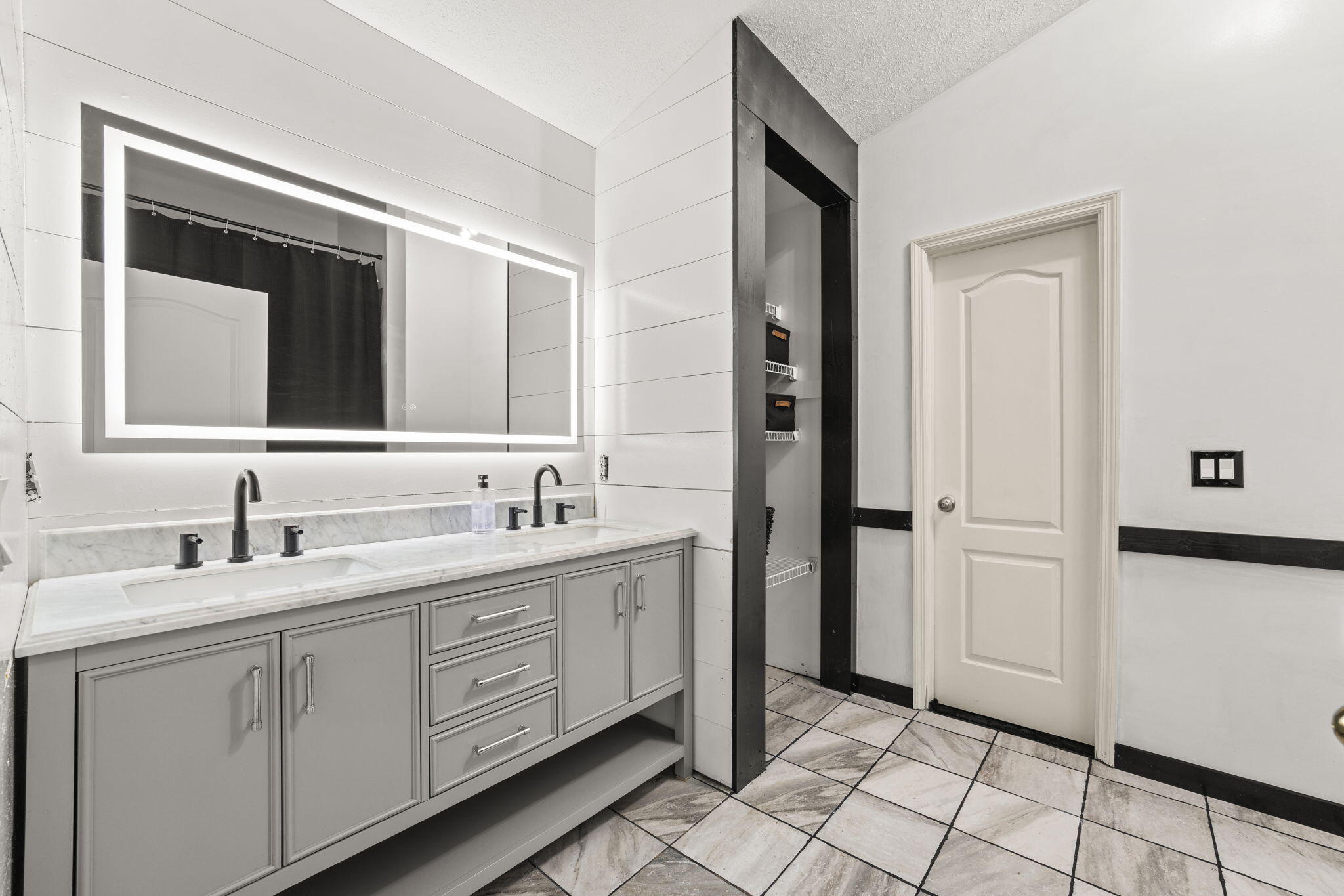 17826 Front Beach Road Panama City Beach, FL 32413 - Photo 20 of 34 a bathroom with a double vanity sink and a mirror
