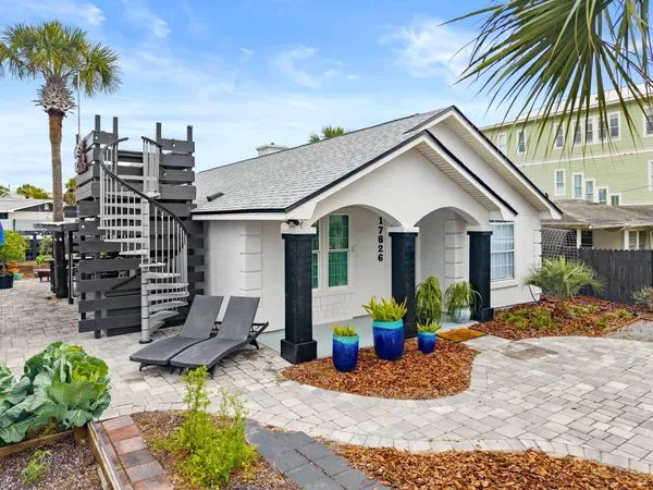 a front view of house with yard outdoor seating and barbeque oven