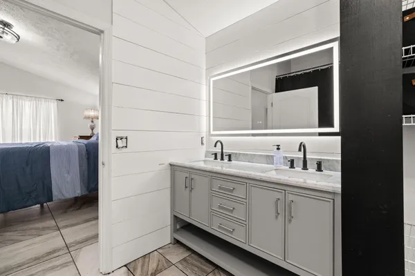a bathroom with a double vanity sink and mirror