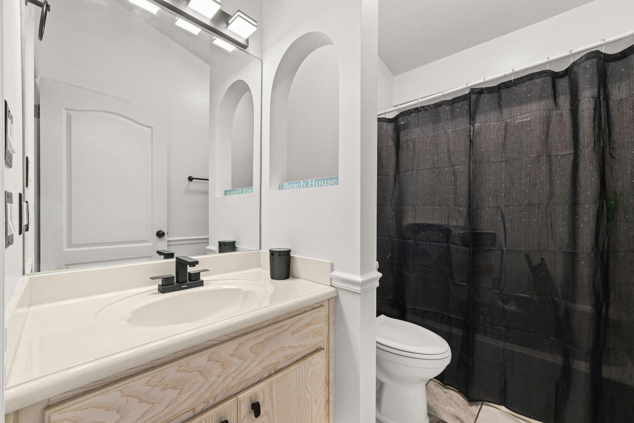 17826 Front Beach Road Panama City Beach, FL 32413 - Photo 22 of 34 a bathroom with a sink a toilet and shower