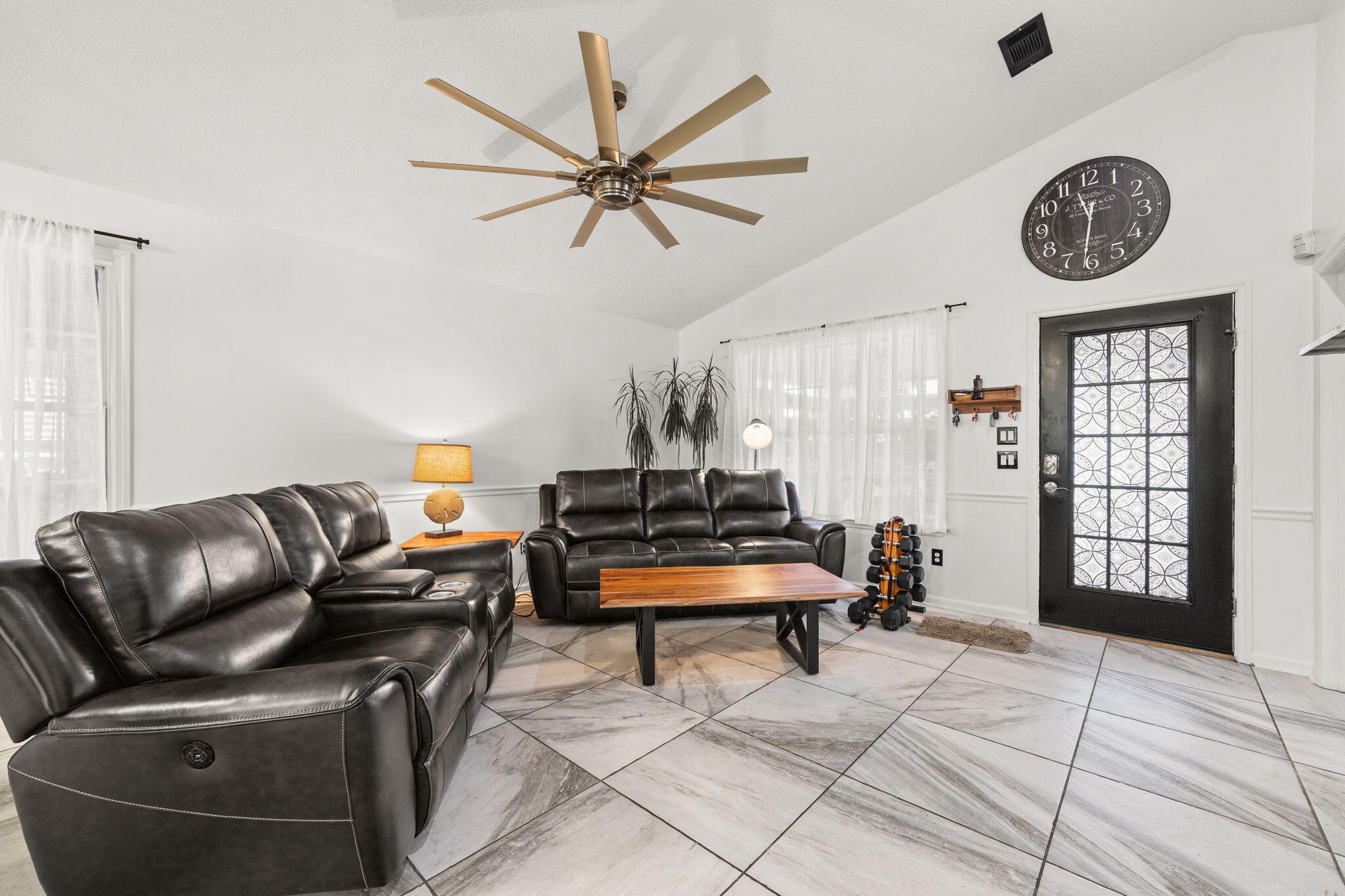 17826 Front Beach Road Panama City Beach, FL 32413 - Photo 9 of 34 a living room with furniture a clock and a window