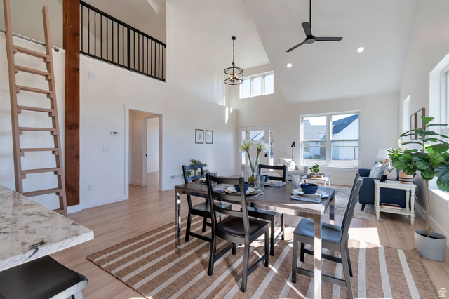 1820 West Farmhouse Flats Road Peoa, UT 84061 - Photo 67 of 79 Open-concept living area featuring vaulted ceilings, light wood-finish flooring, and a second-story loft with a black metal railing