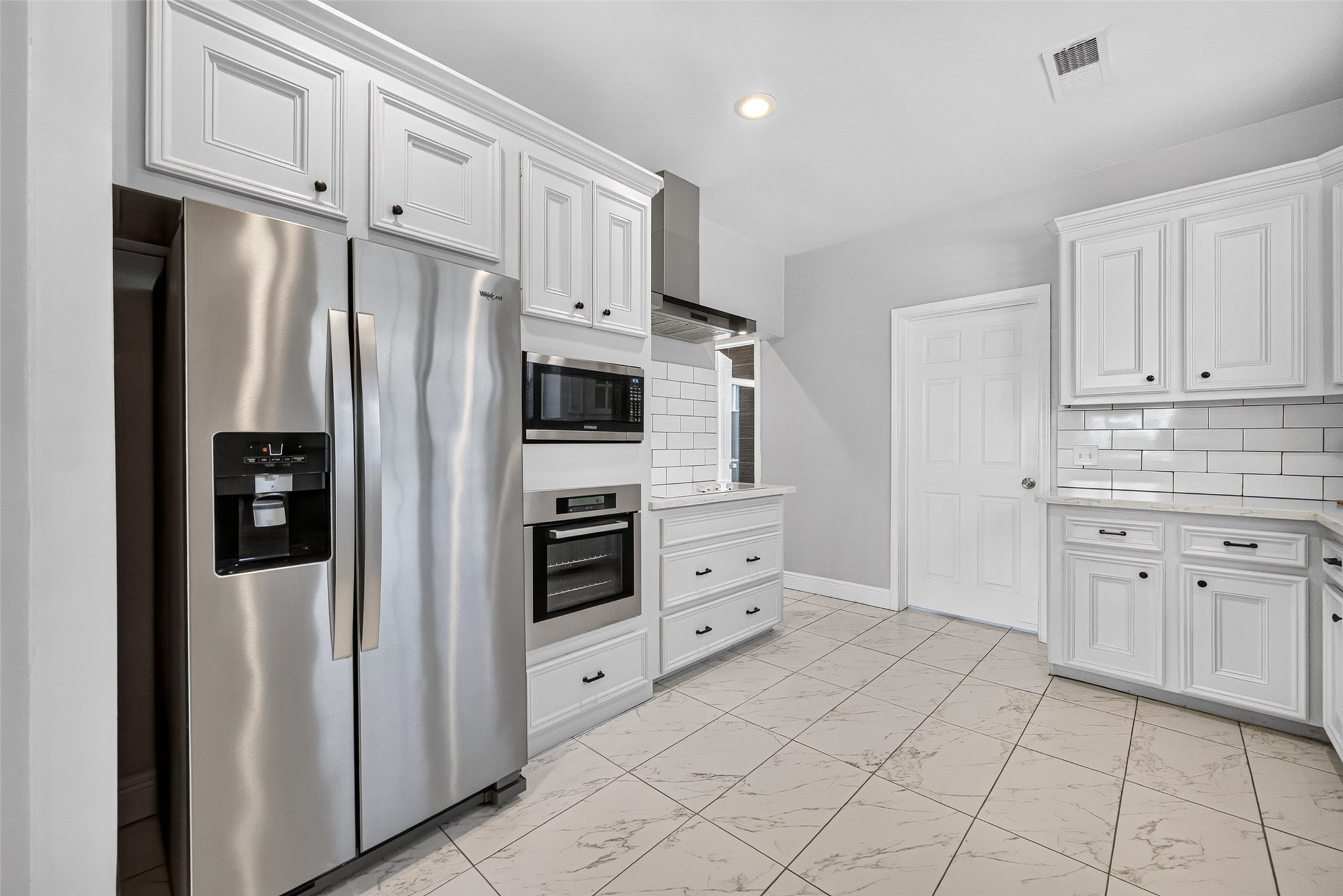 4401 Hain Street Houston, TX 77009 - Photo 11 of 22 Additional kitchen cabinetry provides generous storage, complemented by stainless-steel appliances and built-in microwave and oven.