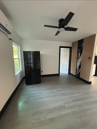 an empty room with windows and closet