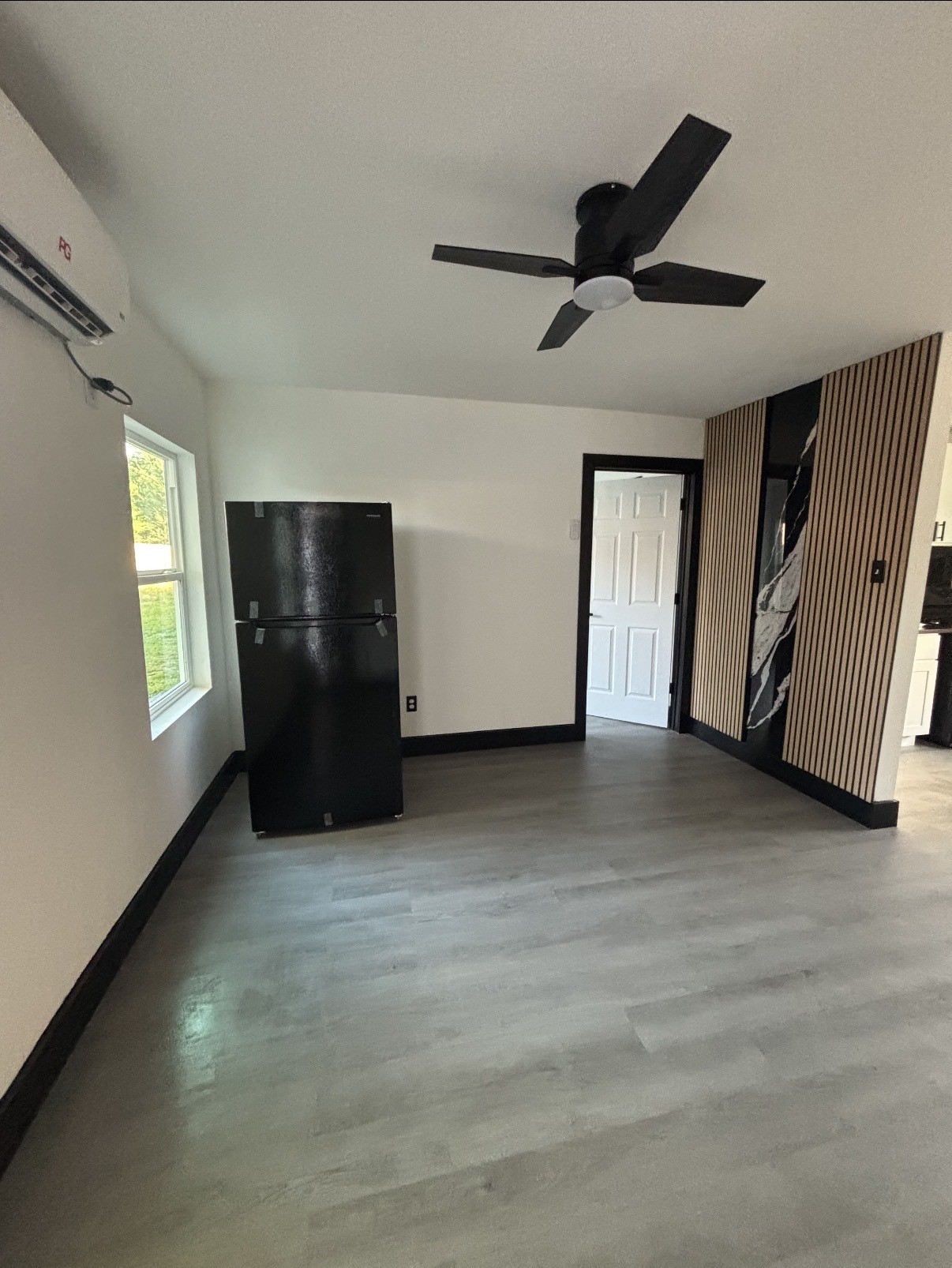 an empty room with windows and closet