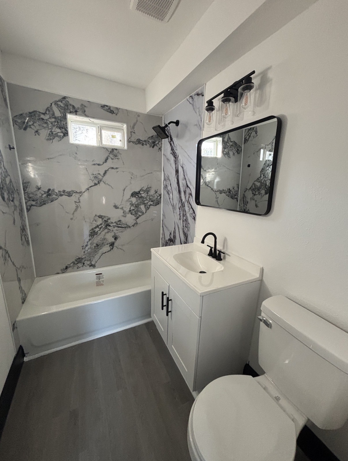 7213 Moline Street, Unit 1 Houston, TX 77087 - Photo 3 of 10 a bathroom with a sink a mirror and a toilet