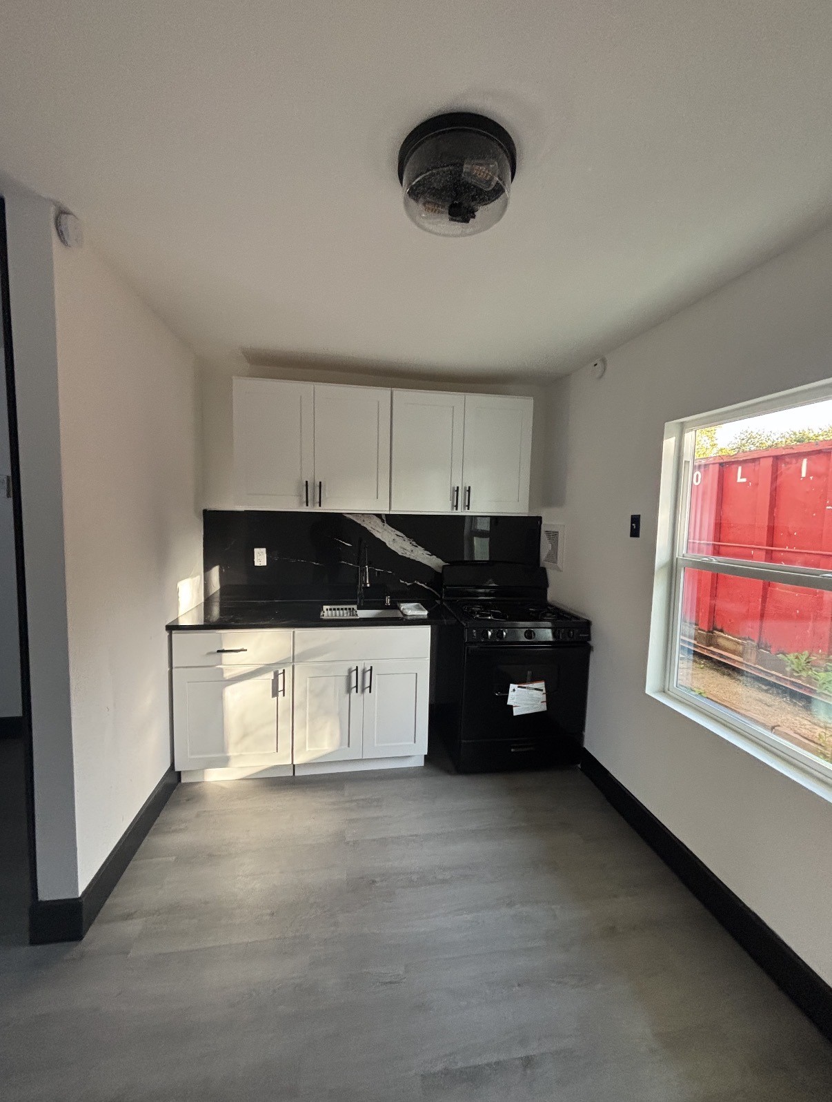 7213 Moline Street, Unit 1 Houston, TX 77087 - Photo 4 of 10 a kitchen with a refrigerator a stove a sink and a window
