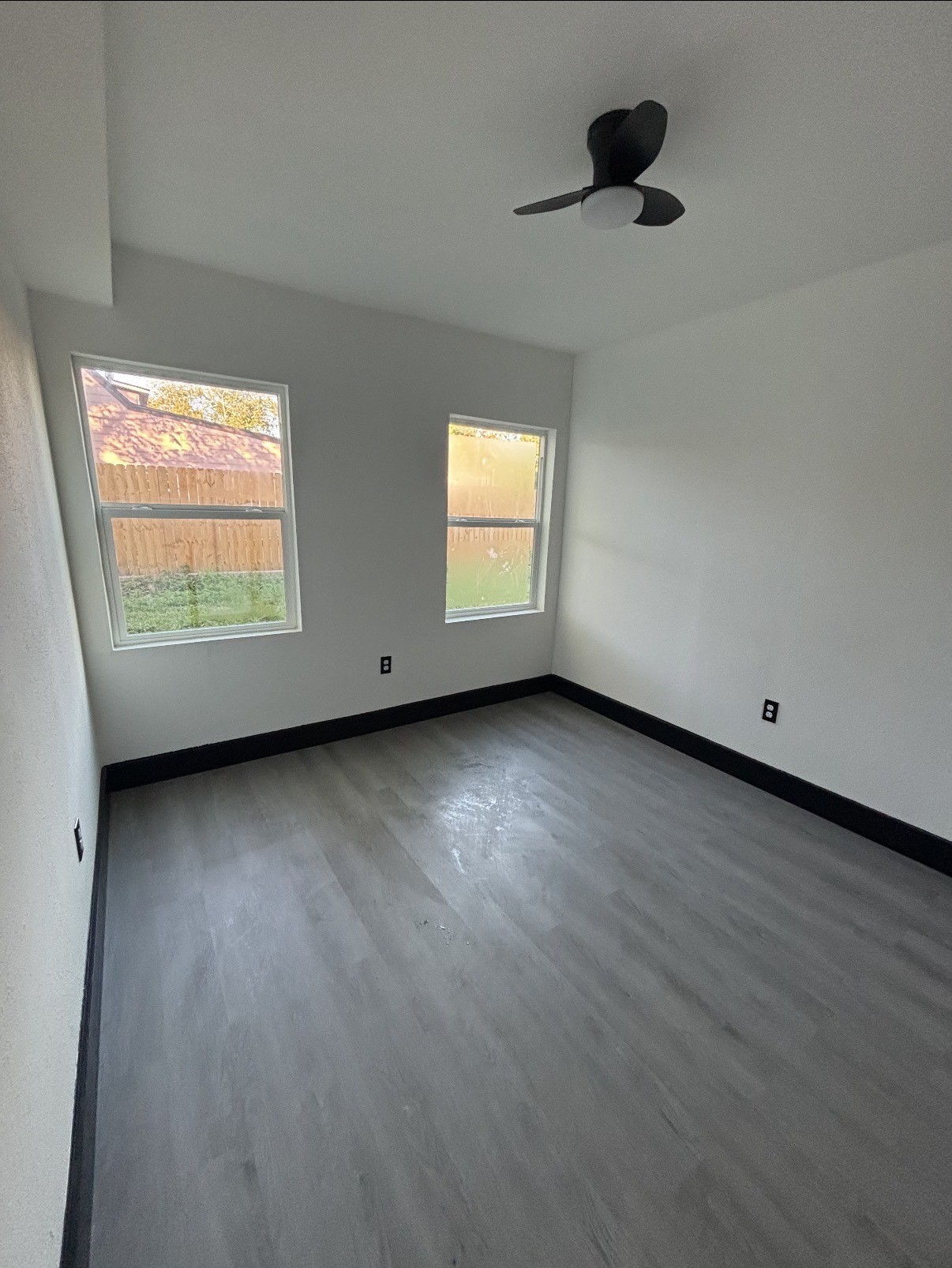 7213 Moline Street, Unit 1 Houston, TX 77087 - Photo 6 of 10 an empty room with wooden floor and windows