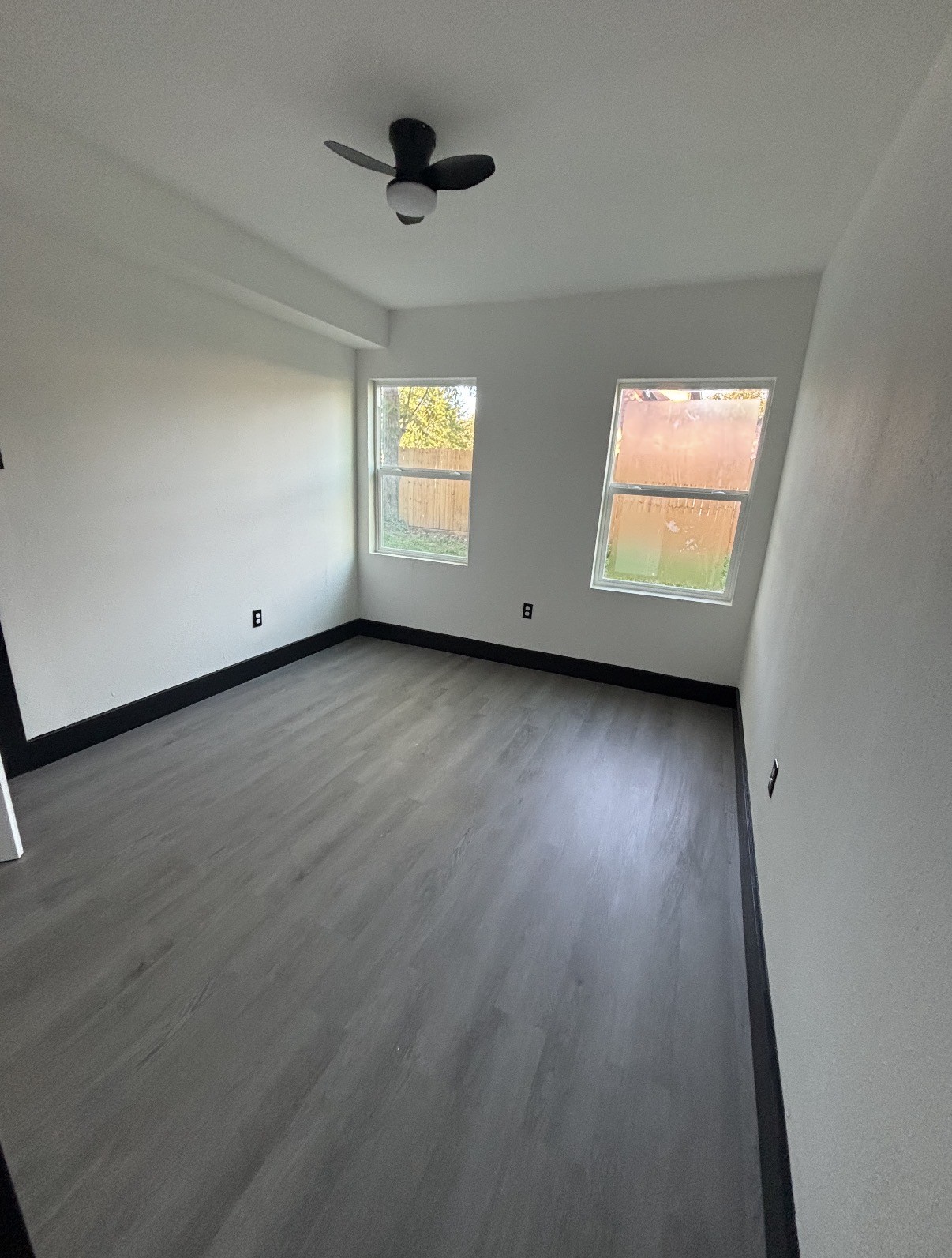 7213 Moline Street, Unit 1 Houston, TX 77087 - Photo 8 of 10 an empty room with wooden floor and windows