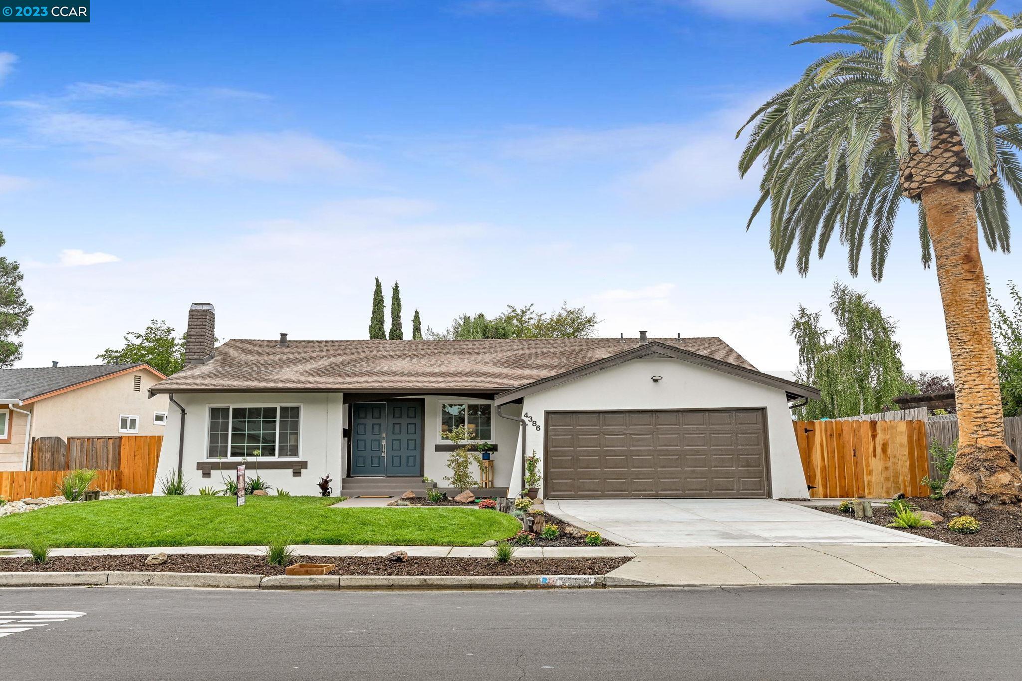 a front view of a house with a garden and entryway