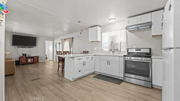 a kitchen with appliances cabinets and a sink