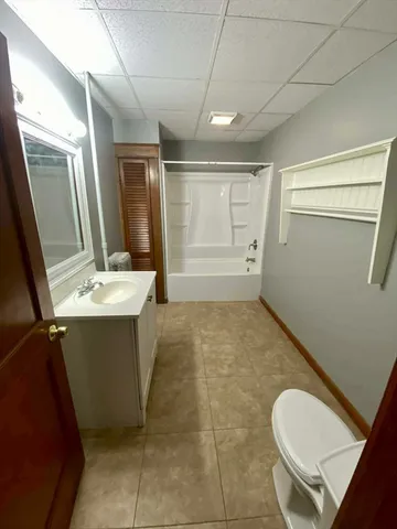 a bathroom with a sink mirror toilet and bathtub