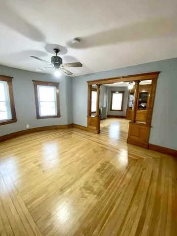 a view of an empty room with a fireplace and a rug