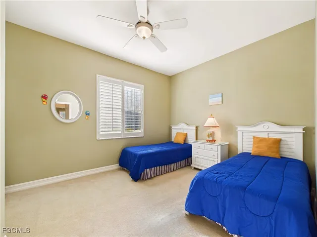 a bedroom with two beds and a window