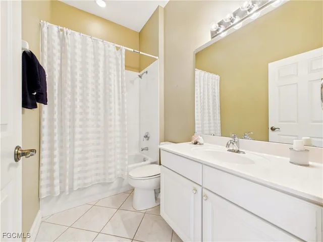 a bathroom with a double vanity sink toilet and shower