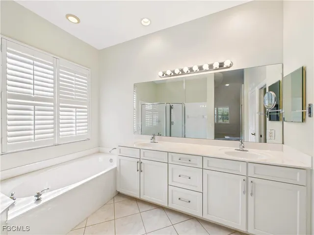 a bath room with a sink and a mirror