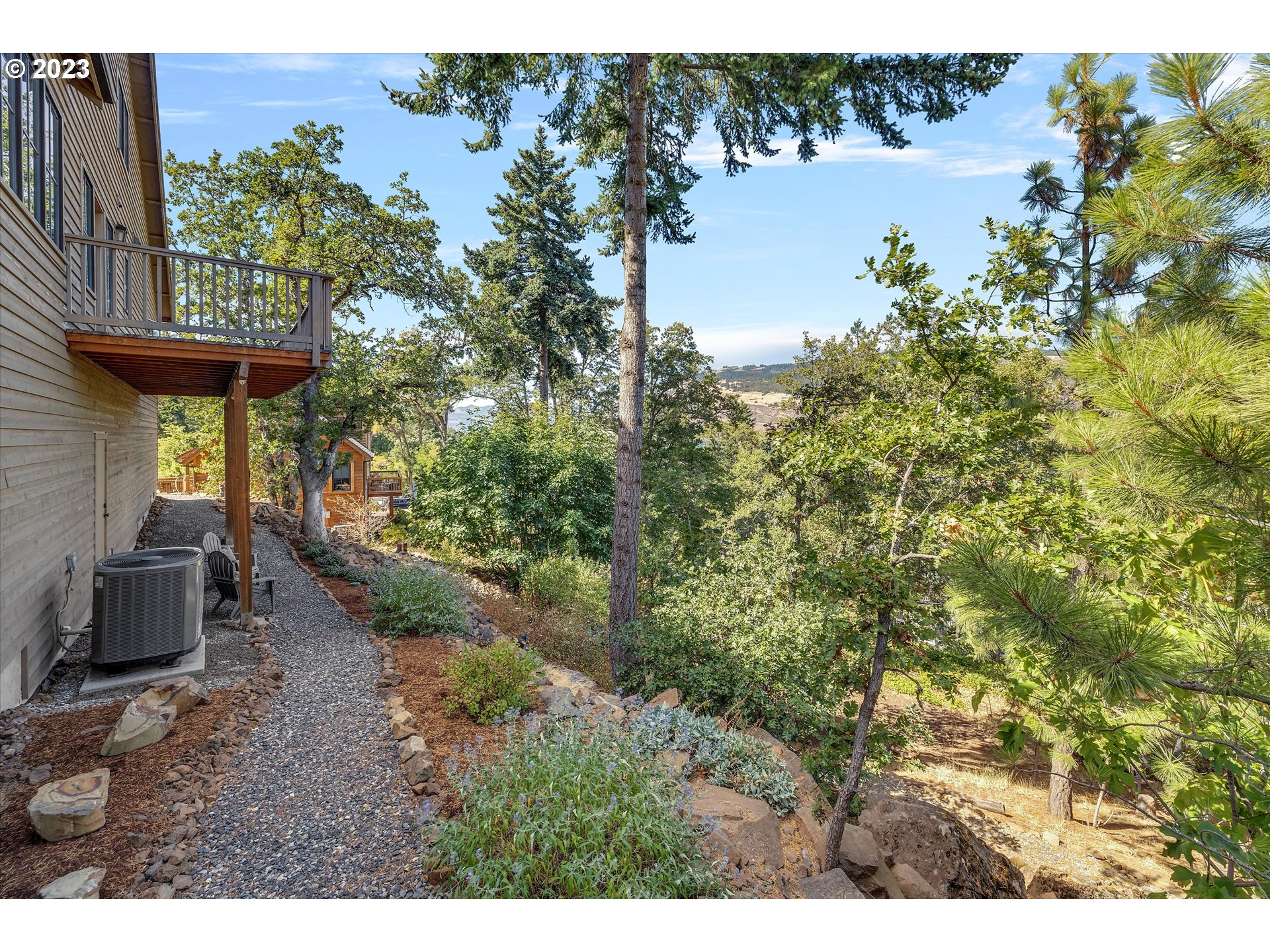 915 Fifth Avenue Mosier, OR 97040 - Photo 26 of 34 a view of a garden with plants and a bench