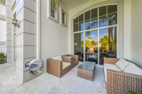 a view of a brick house with a yard and plants