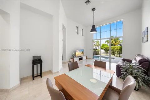 a kitchen with granite countertop white cabinets and stainless steel appliances