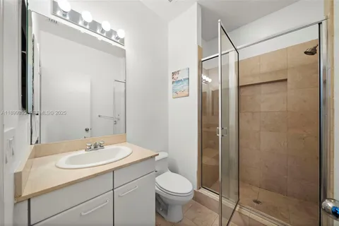 a bathroom with a shower and a glass door