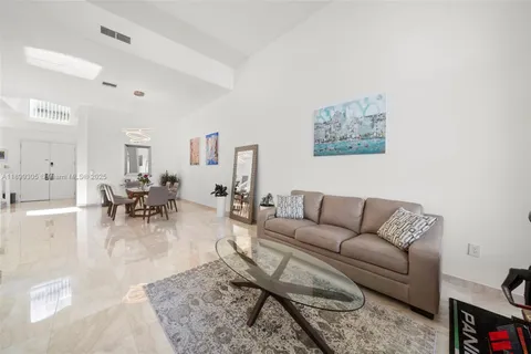 a view of a dining room with furniture and a potted plant