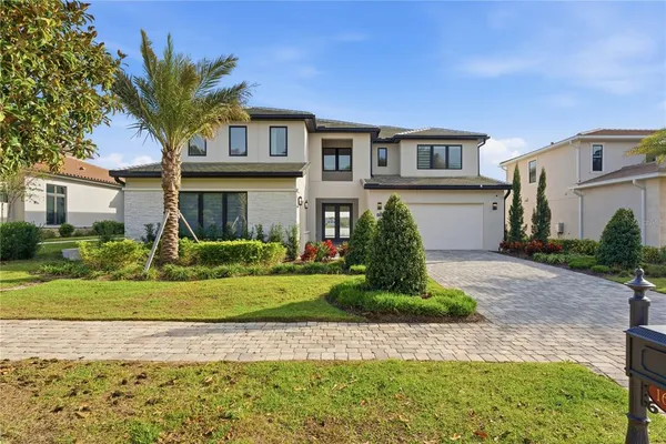 a front view of a house with a garden and plants