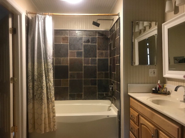 818 Forsling Road Reynolds, GA 31076 - Photo 16 of 35 a bathroom with a granite countertop sink and a bathtub
