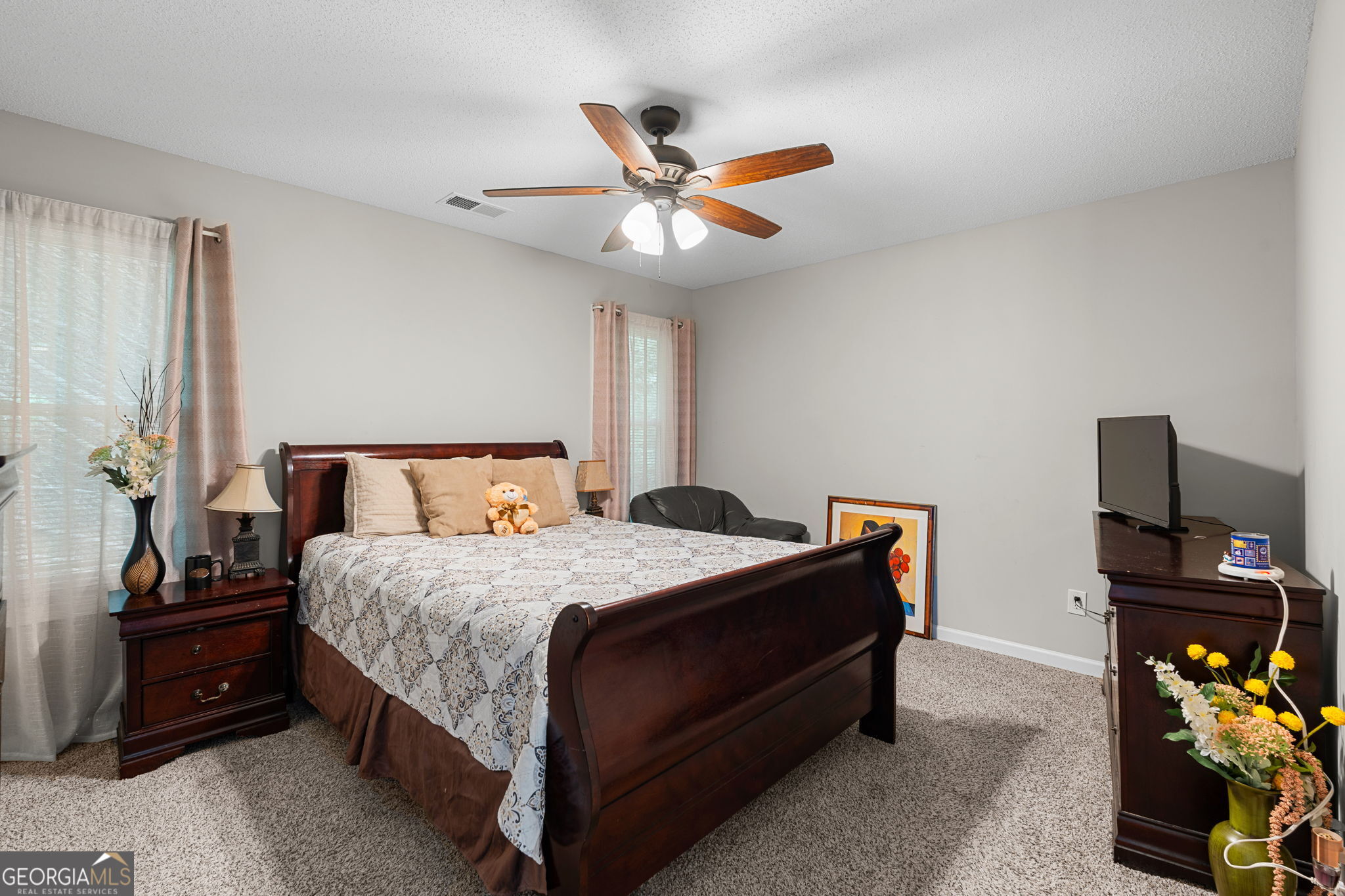 375 Gaelic Way Tyrone, GA 30290 - Photo 24 of 54 a bedroom with a bed and a chandelier