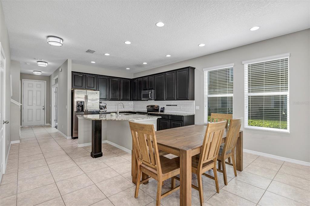7644 Ripplepointe Way Windermere, FL 34786 - Photo 11 of 52 a kitchen with stainless steel appliances granite countertop a refrigerator and a stove top oven