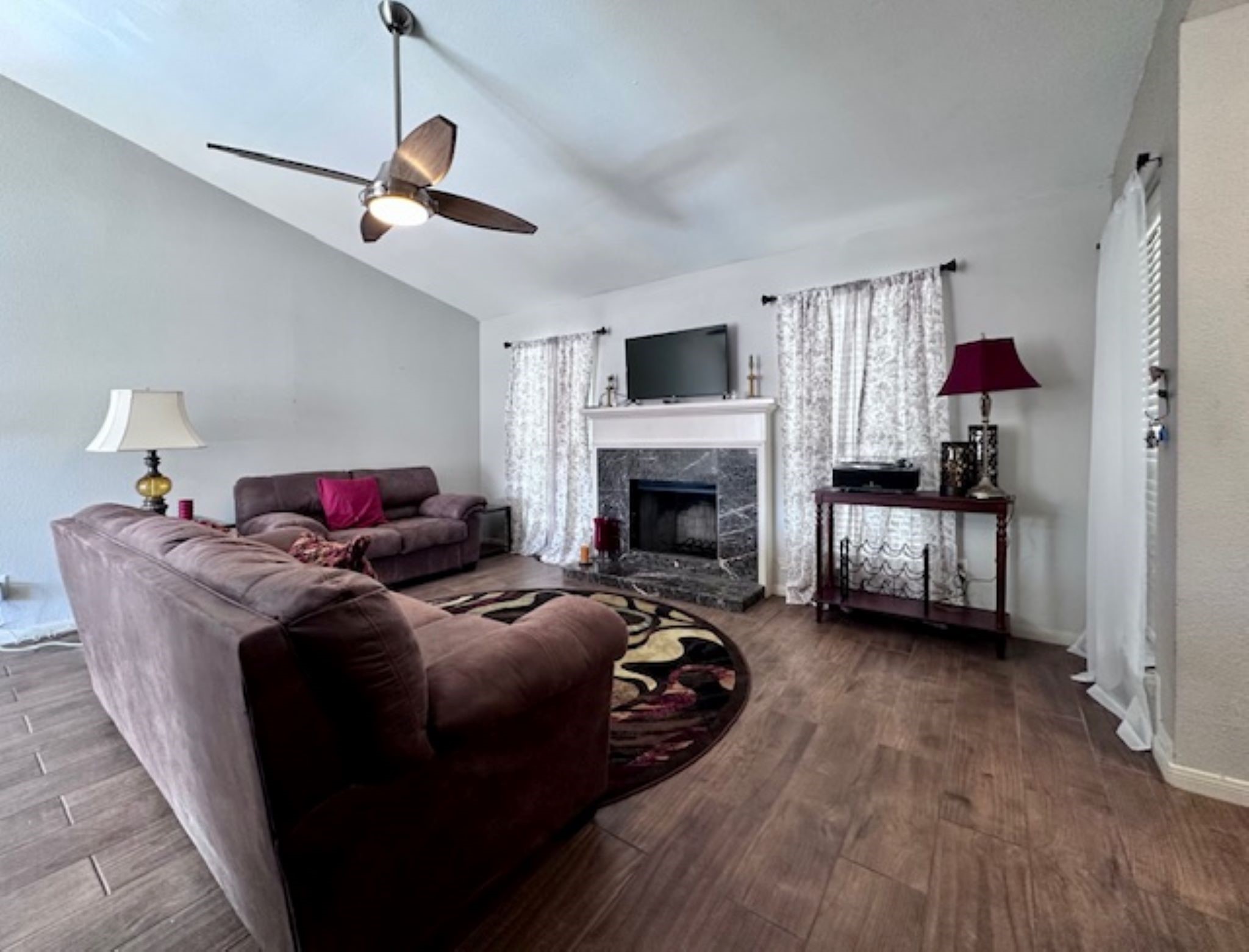 2211 South Kirkwood Road, Unit 35 Houston, TX 77077 - Photo 2 of 13 Vaulted ceilings in the living room with updated wood-like tile flooring.