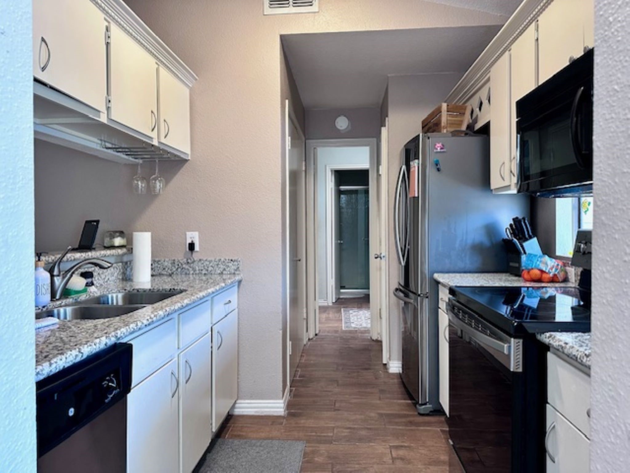 2211 South Kirkwood Road, Unit 35 Houston, TX 77077 - Photo 7 of 13 Kitchen features a pantry and washer/dryer.