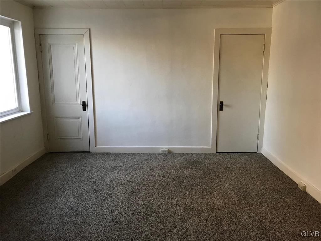 306 1st Street, Unit 1 Slatington, PA 18080 - Photo 7 of 11 an empty room with windows and closet