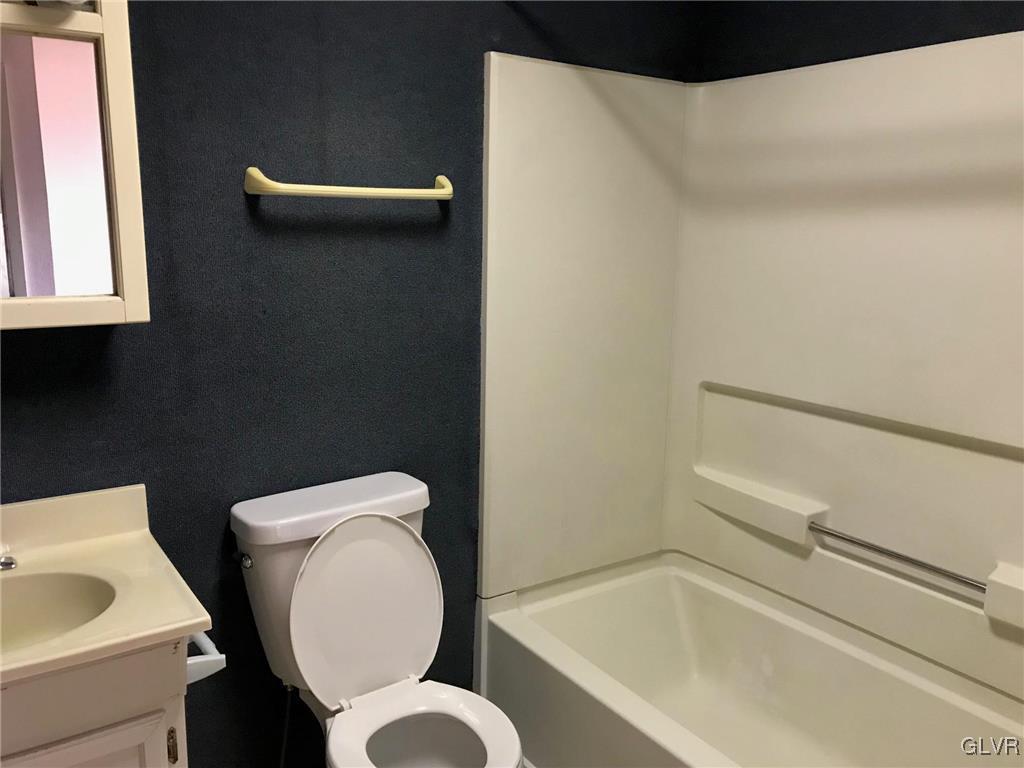306 1st Street, Unit 1 Slatington, PA 18080 - Photo 8 of 11 a bathroom with a toilet and a sink
