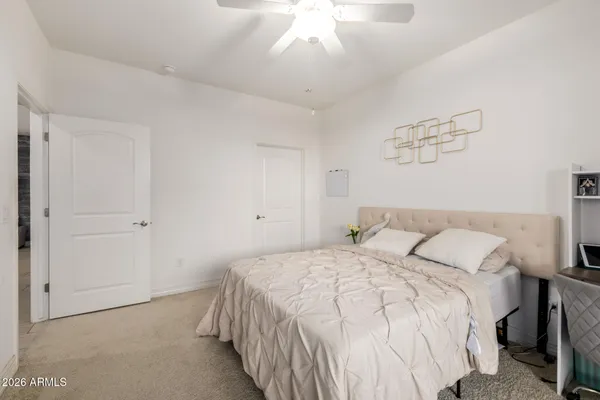 a bedroom with a bed and a chandelier