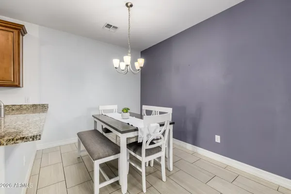 a view of a dining room with furniture and chandelier