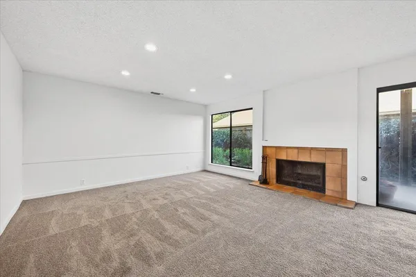 an empty room with sliding glass door and shower