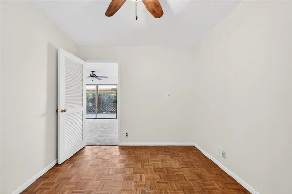 a patio with table and chairs and potted plants